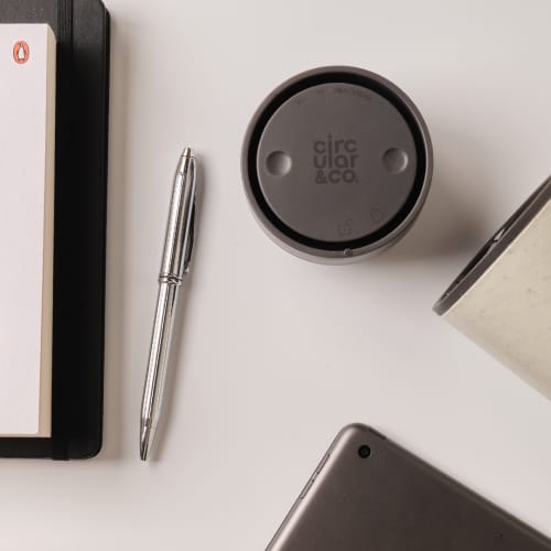 Lifestyle image of the Circular & Co 8oz Reusable Coffee Cup in Black branded with your company logo