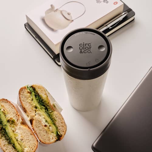 Lifestyle image of the Circular & Co 12oz Reusable Coffee Cup in Black from Total Merchandise