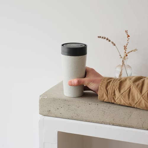 Lifestyle image of the Circular & Co 12oz Reusable Coffee Cup in Black from Total Merchandise