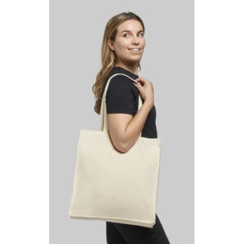 Lifestyle image of the Odessa Natural Cotton Tote Bags with a design from Total Merchandise