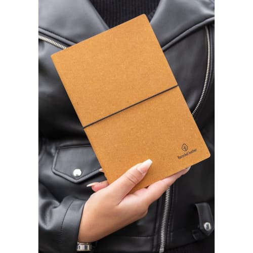 Lifestyle image of the A5 Recycled Leather Notebook with a printed design from Total Merchandise