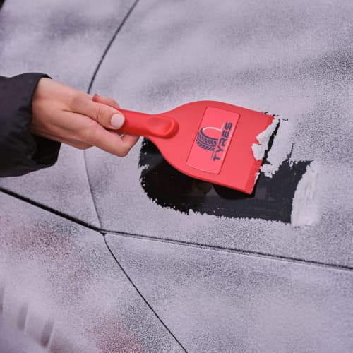 UK Printed Select Recycled Plastic Ice Scrapers in Red Clearing a Window by Total Merchandise