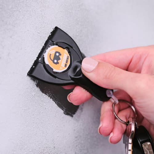 Image of Branded Eco Trolley Coin Ice Scraper Keyring Being Used on Windscreen by Total Merchandise