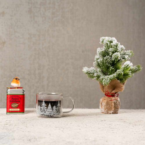 Custom Printed Mulling Spice Tins Next to a Cup of Mulled Wine from Total Merchandise