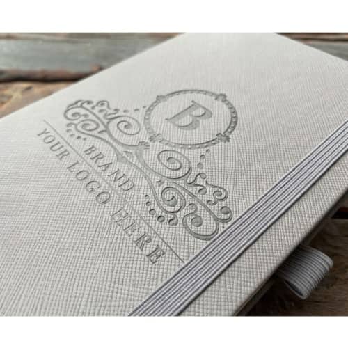 An image of a debossed design on the Eco Friendly Ruled Ortisei Appeel Notebooks