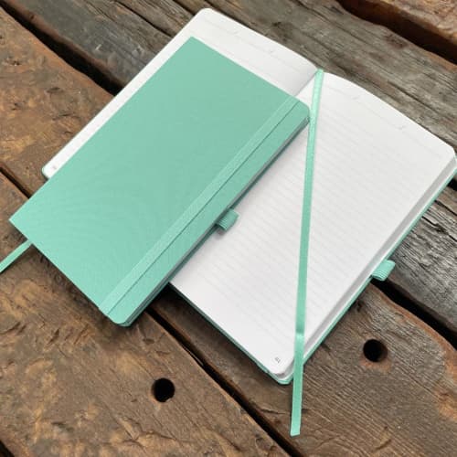 Flat opened image of the Oceano Recycled Bottle Notebook from Total Merchandise