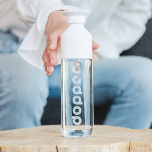 Lifestyle image of the 400ml Glass Dopper Bottle with a design from Total Merchandise