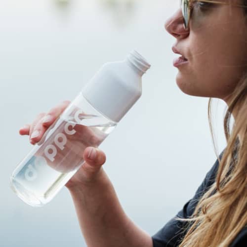 Lifestyle image of the 400ml Glass Dopper Bottle with a design from Total Merchandise