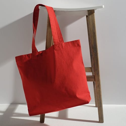 Lifestyle image of the Branded Handle Recycled Tote Bag in Red from Total Merchandise