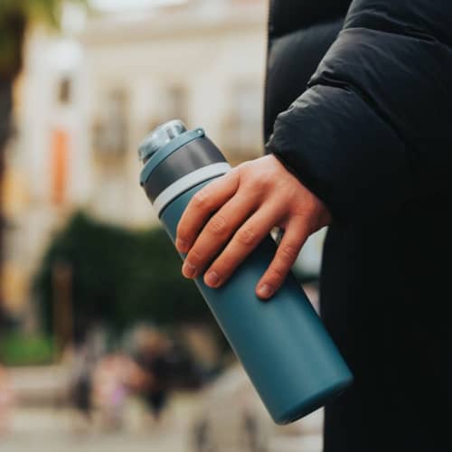 Lifestyle image of the Omni Sip Recycled Lockable Bottle from Total Merchandise