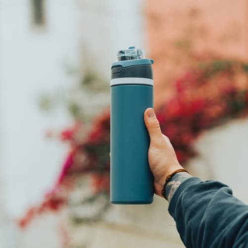 Lifestyle image of the Omni Sip Recycled Lockable Bottle from Total Merchandise