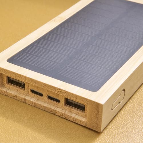 Lifestyle image of the Bamboo Solar Power Bank in Brown with your logo from Total Merchandise