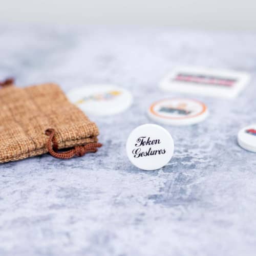 Lifestyle image of the 24mm Drinks Token customised with your company logo from Total Merchandise