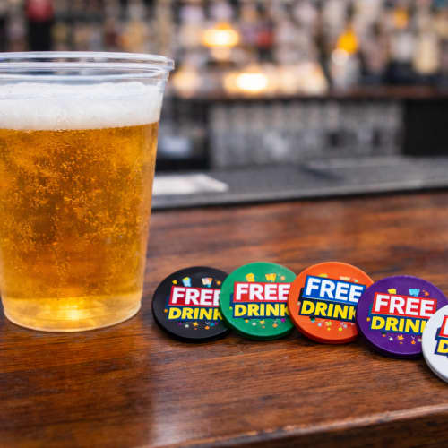 Lifestyle image of the 24mm Drinks Token customised with your company logo from Total Merchandise