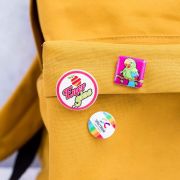 Lifestyle image of the 25mm Circle Plastic Button Badges with a design from Total Merchandise