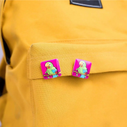 Lifestyle image of the 25mm Square Plastic Button Badges with a design from Total Merchandise
