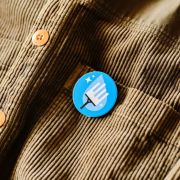 Lifestyle image of the 45mm Circle Plastic Button Badges with a design from Total Merchandise
