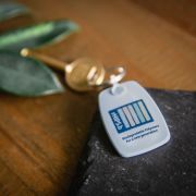 Recycled Biodegradable Plastic Keyrings on a table with a key attached to it by Total Merchandise