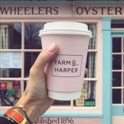 Eco Compostable Paper Cups with Lids in Someone's Hand Printed with a Design by Total Merchandise