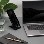 Lifestyle image of the RCS Recycled Plastic Foldable Phone Stand in Black from Total Merchandise