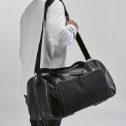 Lifestyle image of the rPET Gym Bag in Black printed with your company logo from Total Merchandise