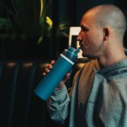 Lifestyle image of the Omni Sip Recycled Lockable Bottle from Total Merchandise
