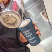 Lifestyle image of the 8oz Circular & Co. Reusable Coffee Cup Made From Recycled Fabric