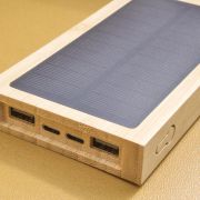 Lifestyle image of the Bamboo Solar Power Bank in Brown with your logo from Total Merchandise