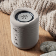 Lifestyle image of the rPET Fabric Boom Wireless Speaker logo branded by Total Merchandise