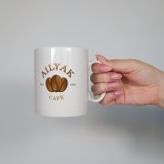 Lifestyle image of the Maxi Print Full Colour Mugs with a design from Total Merchandise