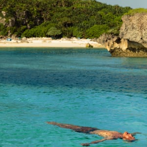 Rosewood Miyakojima:  Man swimming in crystal clear water
