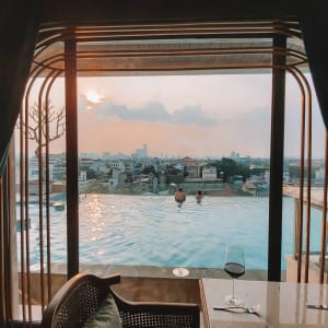 Peridot Grand Luxury Boutique Hotel in Hanoi: Table with pool view