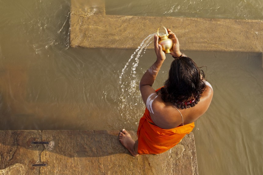 Sadhu offering prayers in the Ganges