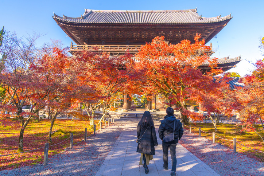 A couple enjoys Autumn colours surrounding Nanzenji Temple in Kyoto.