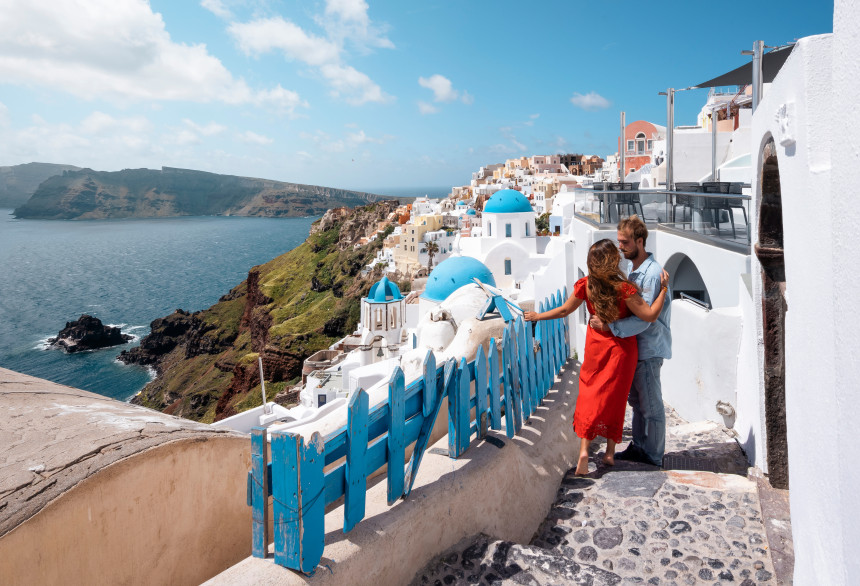 Couple exploring the scenic streets of Oia, Santorini.