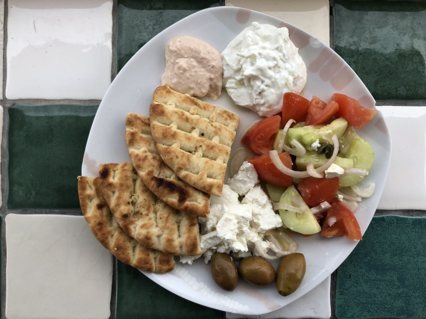 Typical Greek plate: feta, tomato salad, pita, olives, tzatziki and taramasalata