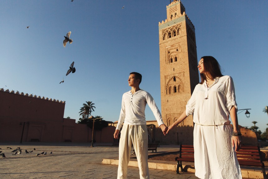 Couple exploring Marrakech in the evening light.