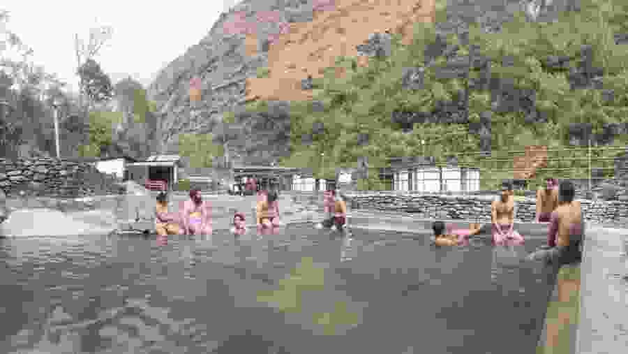 Pilgrims taking a dip in the Tatopani Kund