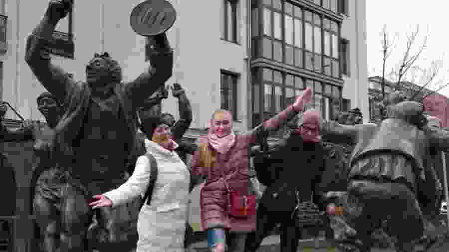 Posing with statues in Tbilisi