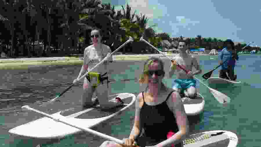 Tourists Paddle-Boarding