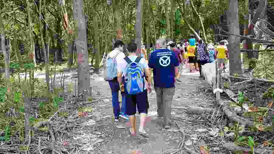 Tourists Walking Through the Amazon Forest