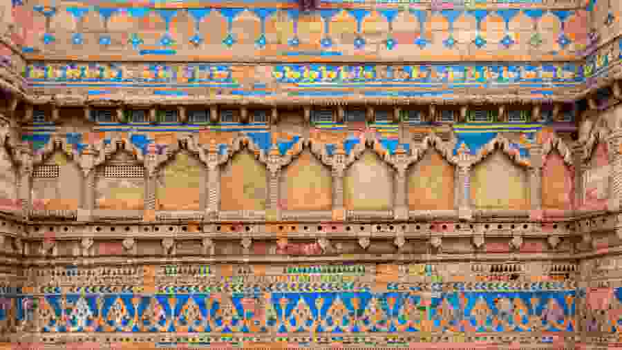 The exterior of Man Singh Palace Gwalior Fort with imposing walls bastions and gates.