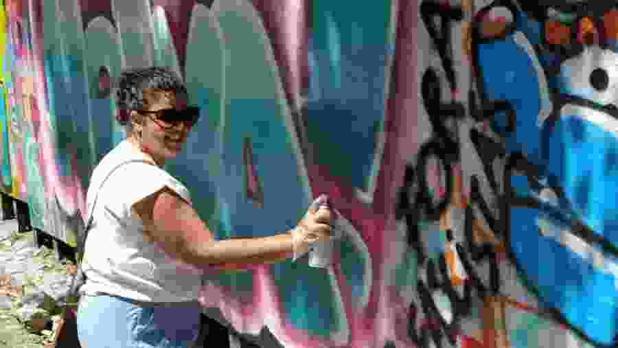 Travelers engaging in street art