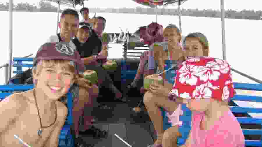 Tourists Having Coconut Water on the Boat