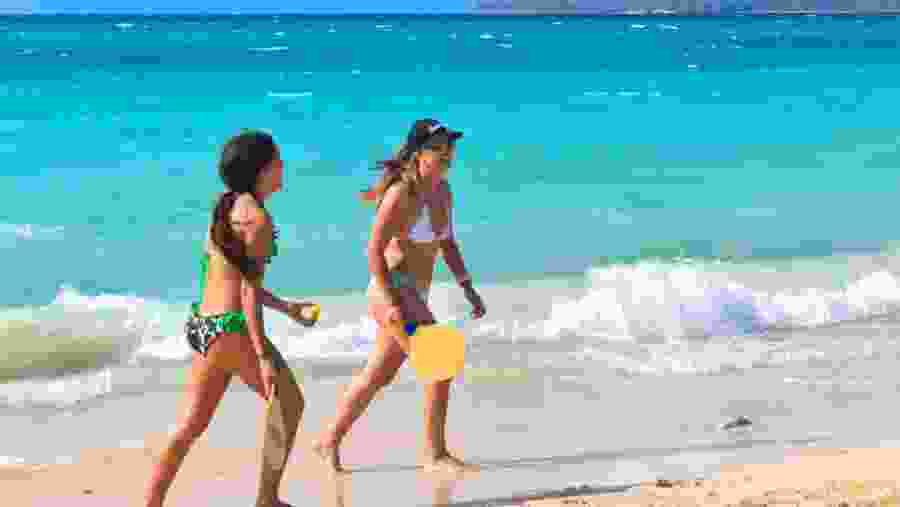 Tourists Playing Tennis At The Beach