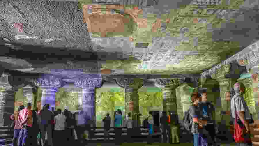 tourists enjoy paintings and rock-cut sculptures the finest surviving ancient Indian art in Ajanta Buddhist cave dated from the 200 BCE to 480 CE in Aurangabad.