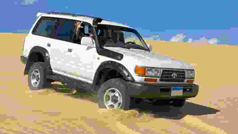 Travelers in a Toyota Land Cruiser in the desert