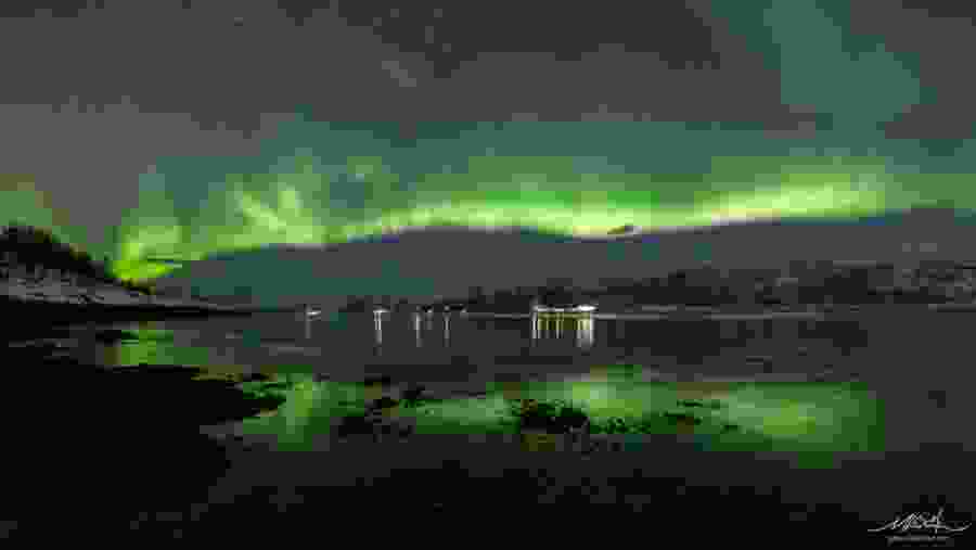 See the reflection of the aurora in the Fjord