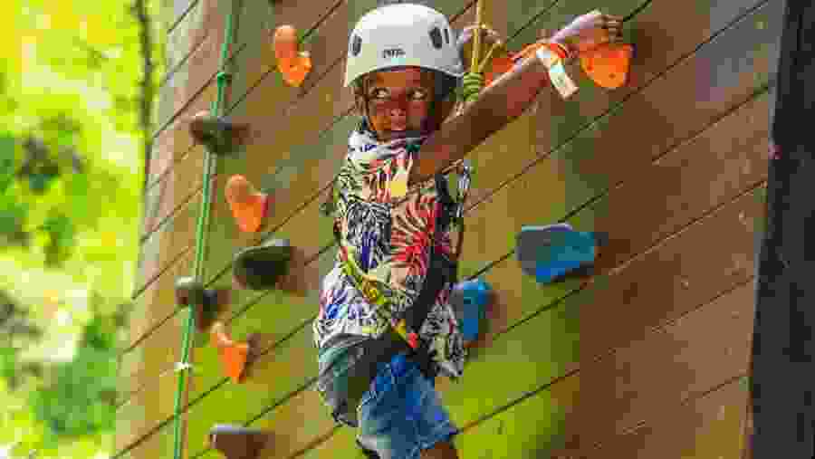 Child enjoying wall climbing in Ella