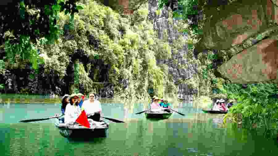 Boating through the river in Trang An Grottoes